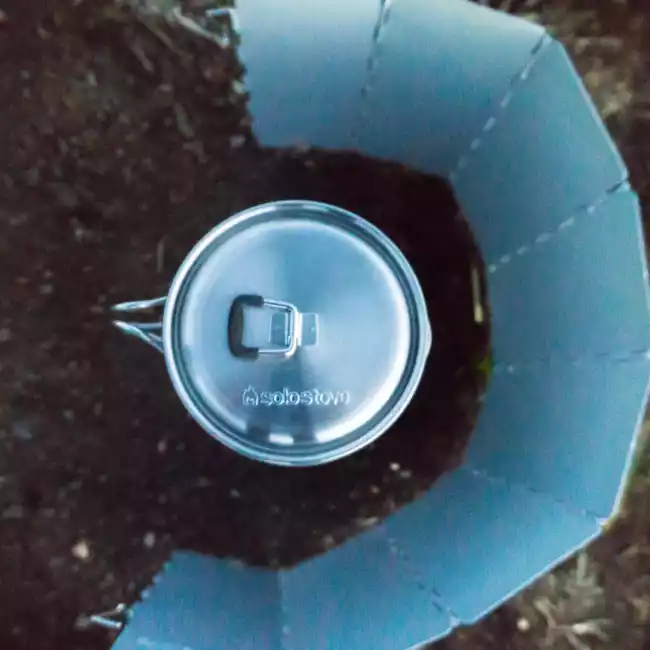 A portable cup with a lid on the ground.