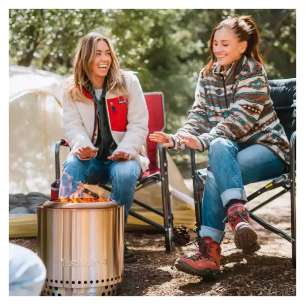 Two women enjoying a campfire with the Solo Stove Stainless Steel Ranger Essential Bundle 2.0 - Portable & "Smokeless" (SHIPS IN 1-4 WEEKS).