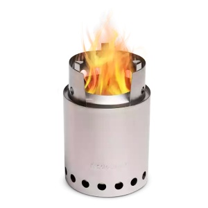 A portable stainless steel camp stove with flames on a black background.
