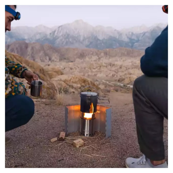 Two men using the Solo Stove Stainless Steel Titan Camp Stove for a portable and "smokeless" campfire experience in the desert.
