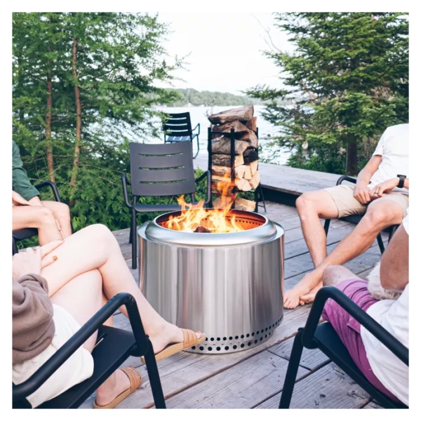 A group of people gathered around a portable and "smokeless" fire pit.