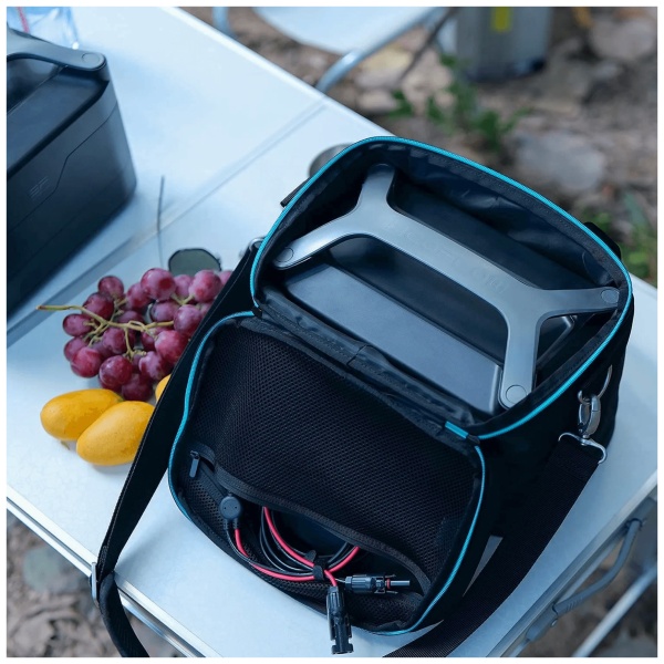 A laptop and an EcoFlow RIVER Bag on a picnic table.
