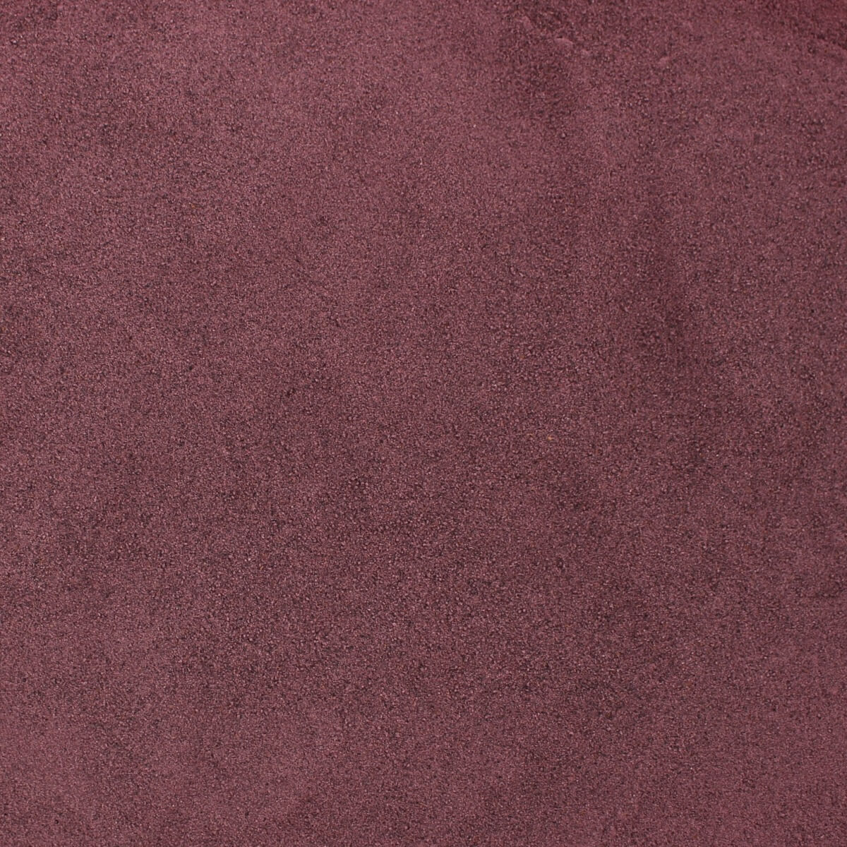 A close up image of a burgundy colored background featuring Harmony House Freeze Dried Blueberry Powder.