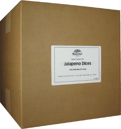 A cardboard box with a box of Jamaican rock and Harmony House Dried Jalapeno Dices.