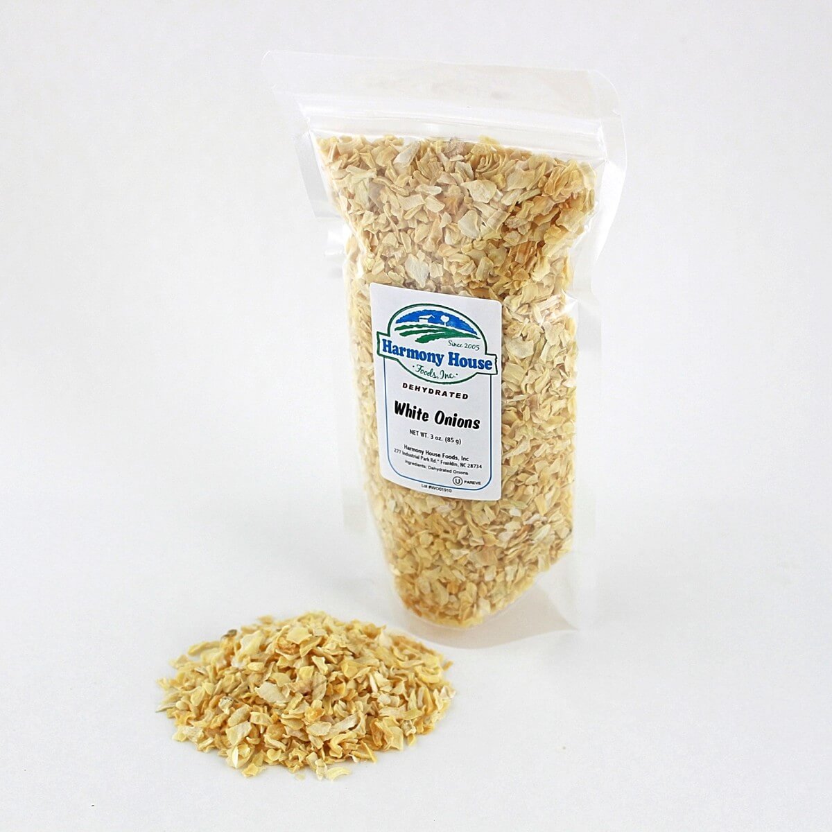 A bag of rolled oats on a white surface, Harmony House Dried Onions.
