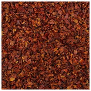 A close up of a pile of dried red chili peppers packed with Harmony House Organic Dried Tomato Flakes.