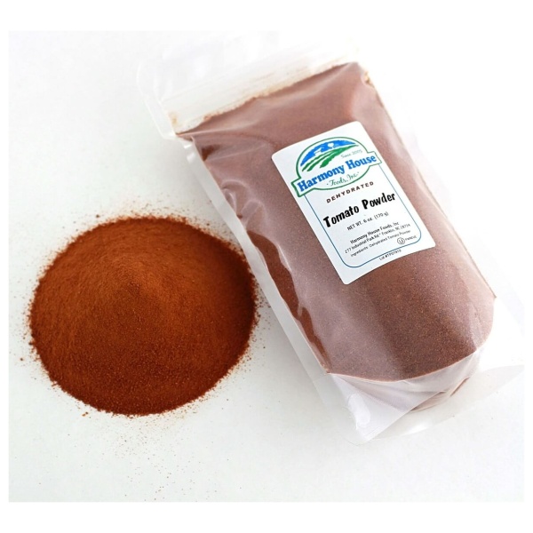 A bag of Harmony House Tomato Powder (6 oz) next to another bag.