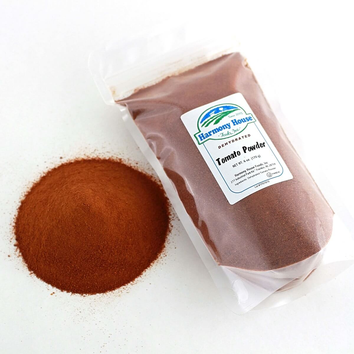 A bag of Harmony House Tomato Powder (6 oz) next to another bag.