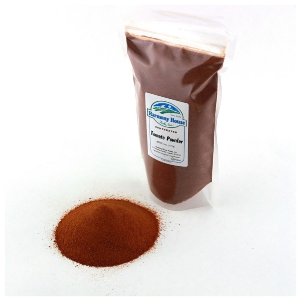 A bag of red Harmony House Tomato Powder on a white surface.
