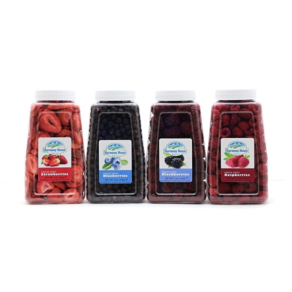 Description: Four bottles of berry juice are lined up on a white background, Harmony House Berry Medley SHIPS.