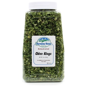 A jar of olive kings on a white background with Harmony House Dried Chives.