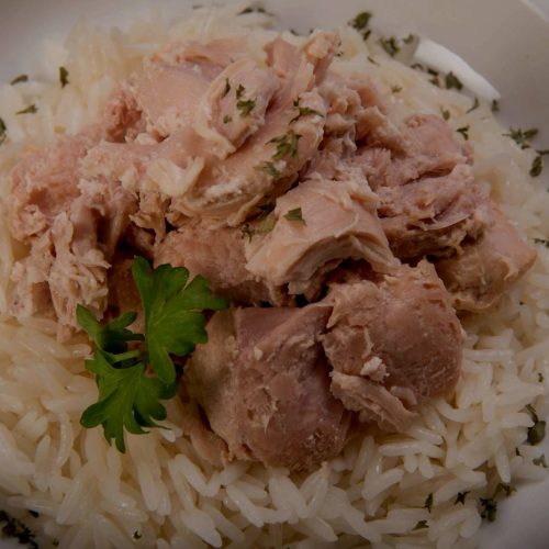 Emergency food storage: A white plate with tuna and rice, providing essential protein.
