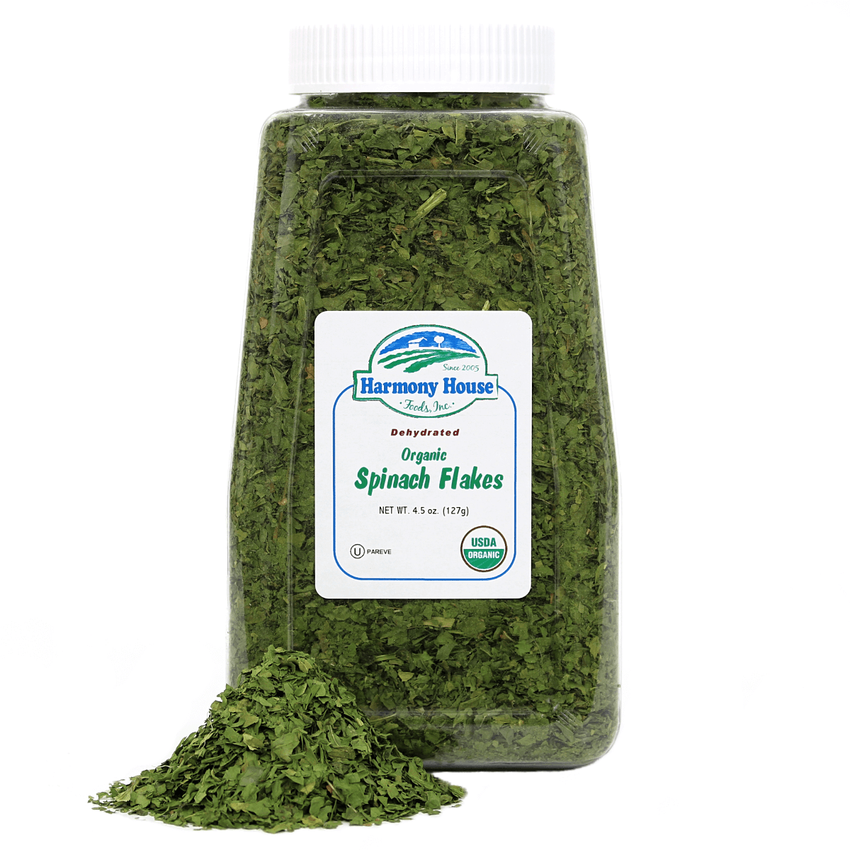 A jar of spinach leaves on a white background with Harmony House Organic Dried Spinach Flakes.
