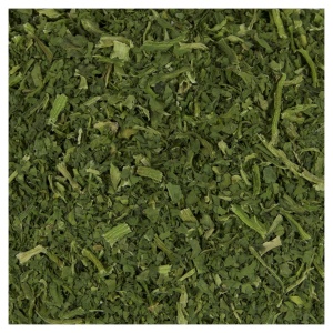A close up of a pile of green leaves for Harmony House Dried Spinach Flakes (20 lbs).