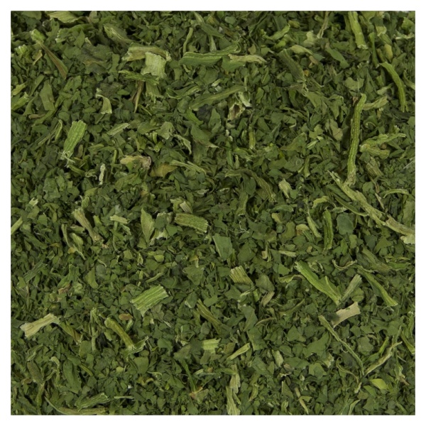 A close up of a pile of green leaves for Harmony House Dried Spinach Flakes (20 lbs).