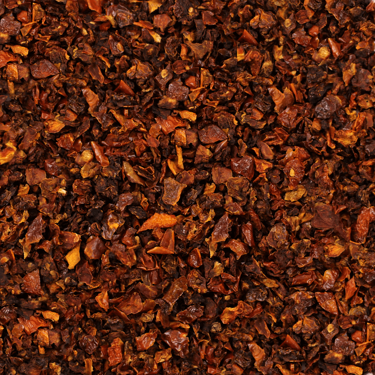 A close up image of a pile of brown spices, including Harmony House Dried Tomato Dices (32 oz).