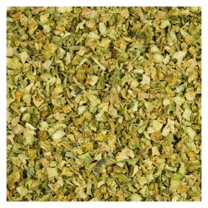 A pile of diced dried herbs on a white surface.