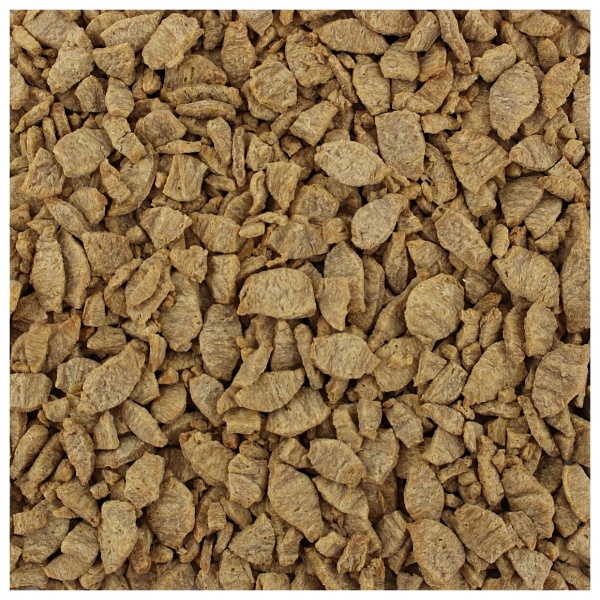 A close up image of a pile of brown chips - Harmony House Chicken Style Chunks.
