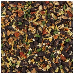A close up of a pile of black beans and spices.