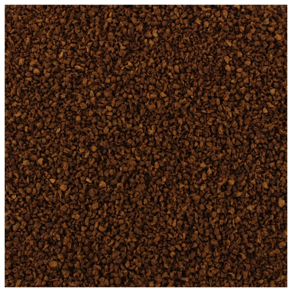 A close up image of a brown sand texture with Taco Flavored Bits.