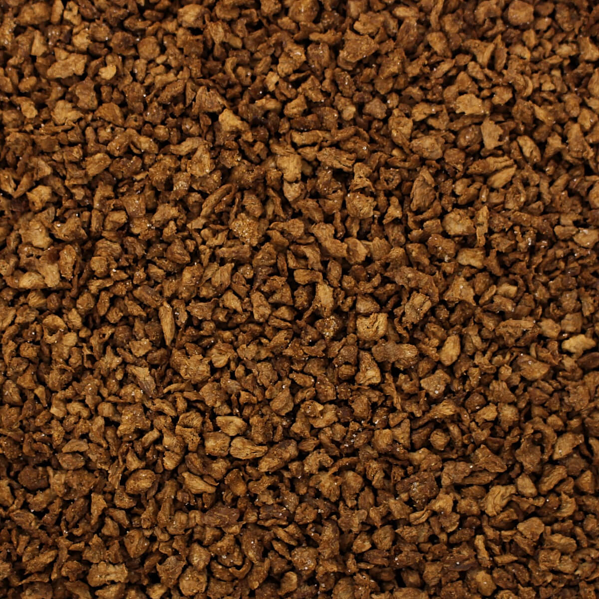 A close up of a pile of brown granules from the Harmony House Deluxe Plant-Based Protein Sampler.