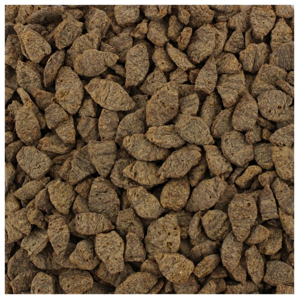 A pile of brown dog food on a white Harmony House Deluxe Plant-Based Protein Sampler (12 Zip Pouches) background.