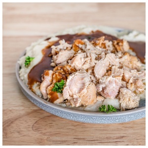 A plate of chicken and gravy for emergency food storage.