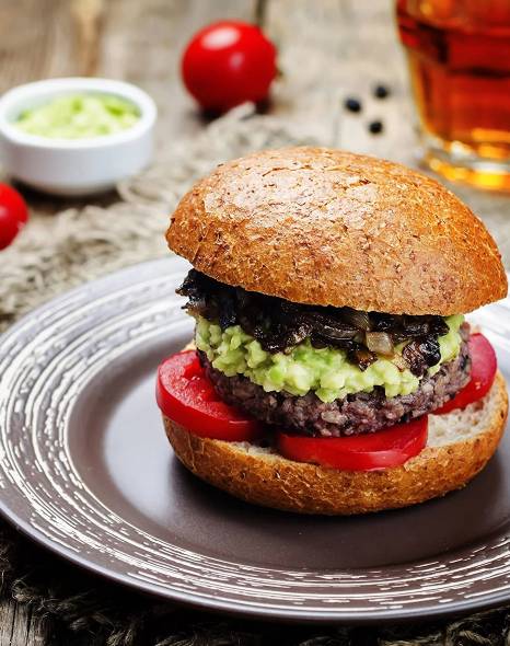 A burger with guacamole and tomatoes for emergency food storage.