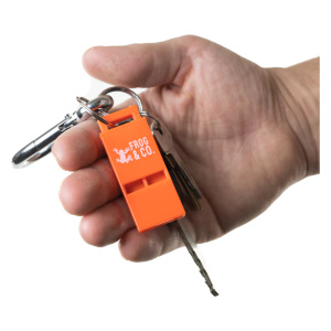 A person holding an orange key ring with a Micro Scream Whistle attached.