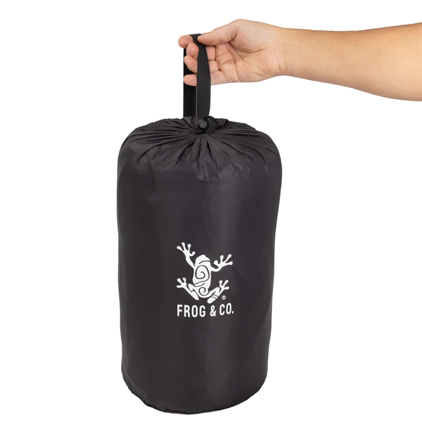 A person holding a black bag with the Frog & Co. logo on it.