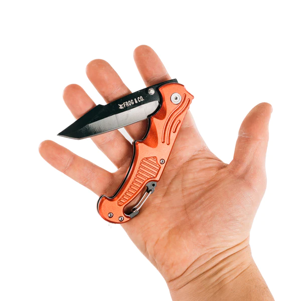 A person holding a Red Survival Pocket Knife by Frog & Co. in their hand.