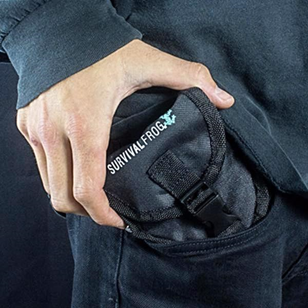 A person holding a black pouch with the word survival express on it.