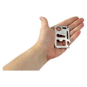 A person's hand holding a small multi-tool from Frog & Co. The Survival Wallet Tool is compact and versatile, perfect for any emergency situation.