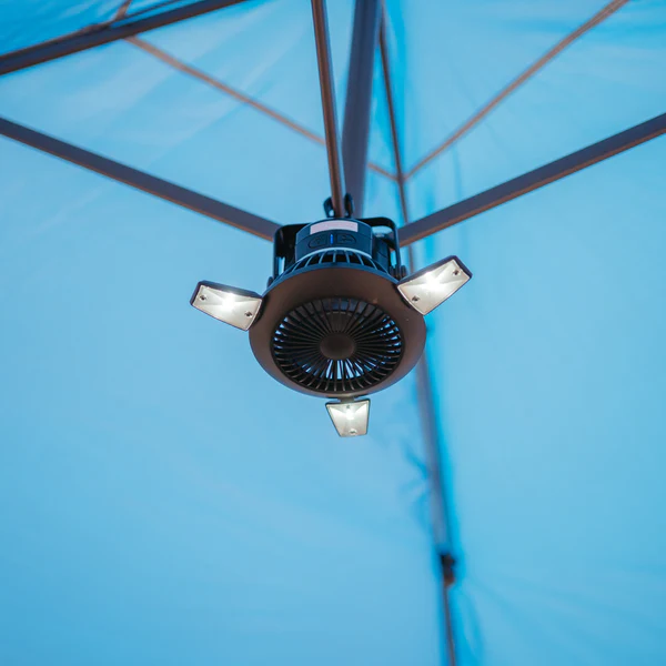 A blue umbrella with a Solar Camping Fan & Light attached to it, available from Frog & Co.
