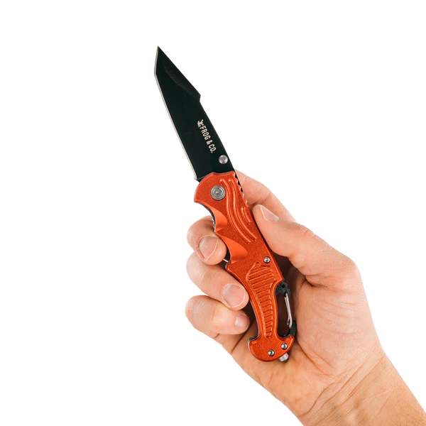 A person holding a red Frog & Co. pocket knife on a white background.