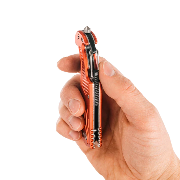 A person's hand holding an orange and black Frog & Co. Red Survival Pocket Knife.