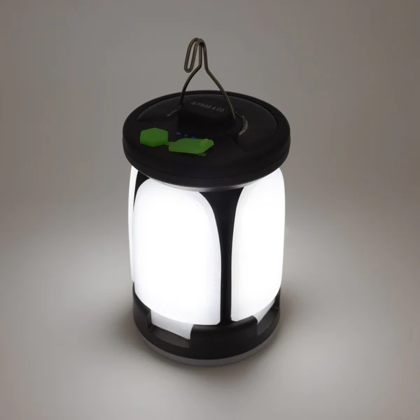 The Frog & Co. QuadPod Camping Lantern features a black and white design with a green light. SHIPS IN 1-2 WEEKS.