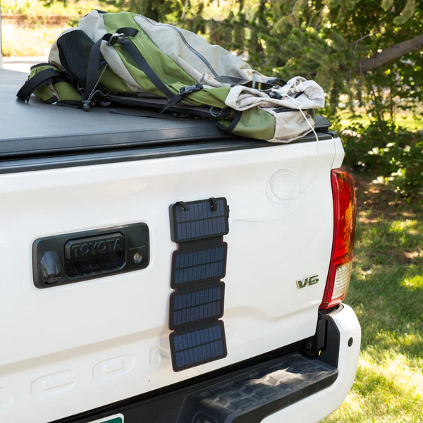 A QuadraPro solar panel is attached to the back of a pickup truck.
