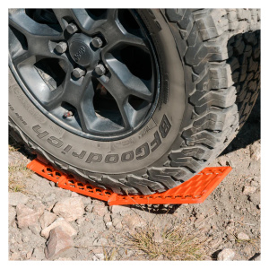 A Tire Traction Mat from Frog & Co. is sitting on an orange grate.