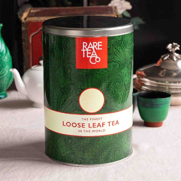 A complete guide to storing tea the right way, featuring a tin of loose leaf tea on a table.